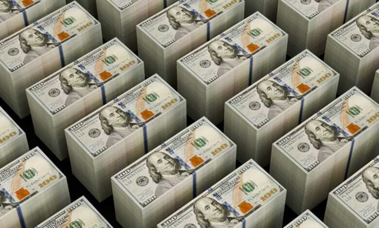 Stacks of hundred dollar bills are shown.