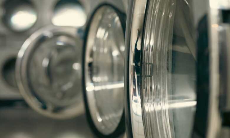 a row of silver and black washing machines
